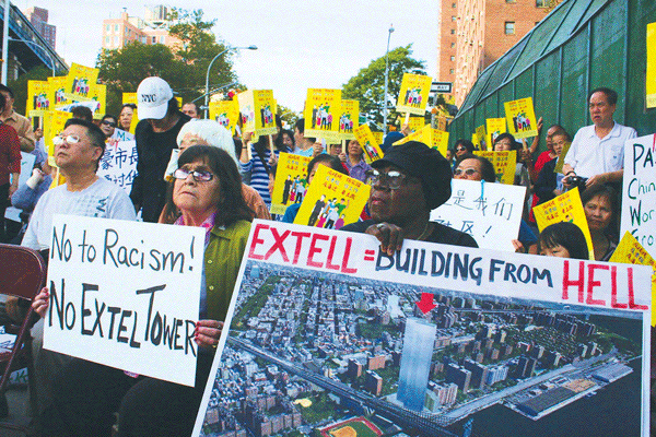 Protesters held up signs of the “Building From Hell,” Extell’s planned high-rise that has become a symbol of overdevelopment in the Lower East Side and Chinatown.  Photos by Yannic Rack