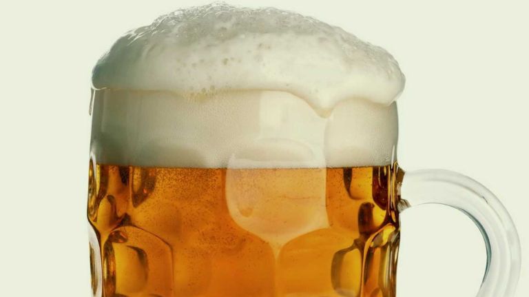 A mug of beer with foam. 