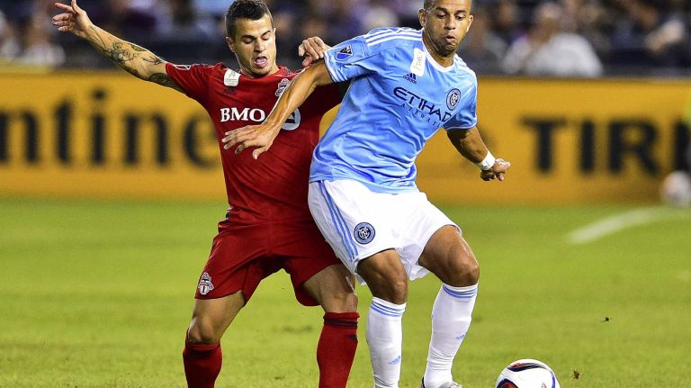 New York City FC defender Jason Hernandez is pursued by Toronto FC midfielder Sebastian Giovinco in an MLS game at Yankee Stadium on Wednesday, Sept. 16, 2015.