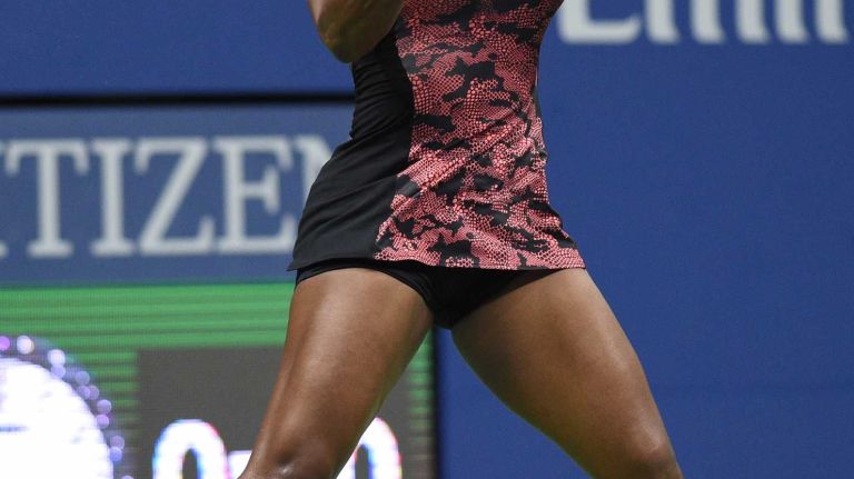 Serena Williams returns to Venus Williams during the women's singles quarterfinals at the U.S. Open tennis tournament on Tuesday, Sept. 8, 2015.