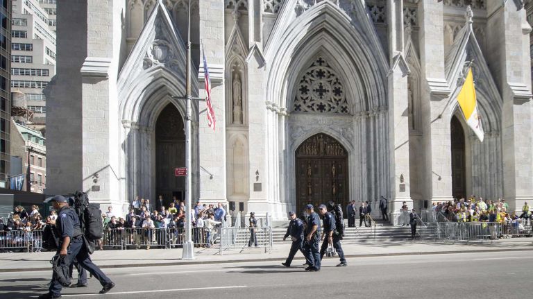 Security teams prepare Fifth Avenue for Pope Francis' motorcade as crowds line up behind barriers outside St. Patrick's Cathedral in Manhattan on Thursday, Sept. 24, 2015.
