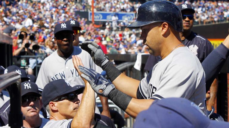 Subway Series: Yankees vs. Mets 67 Carlos Beltran #36 of the New York Yankees celebrates his first inning three run home run against the New York Mets with manager Joe Girardi #28 at Citi Field on Saturday, Sept. 19, 2015.