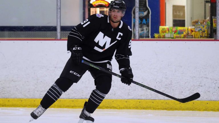 John Tavares #91 of the New York Islanders skates with youth hockey players while modeling the team's new third jersey at Iceworks on Sept. 15, 2015 in Syosset.