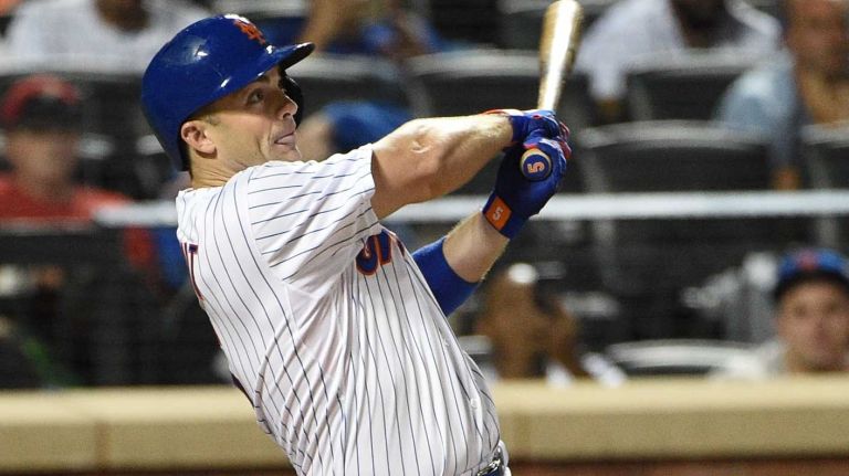 Mets third baseman David Wright hits an RBI double against the Miami Marlins during the seventh inning of a game at Citi Field on Monday, Sept. 14, 2015.