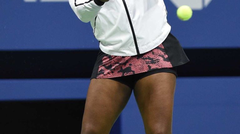 Serena Williams warms up against Venus Williams during the women's singles quarterfinals at the U.S. Open tennis tournament on Tuesday, Sept. 8, 2015.