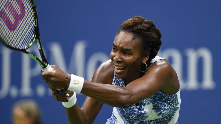 Venus Williams returns to Serena Williams during the women's singles quarterfinals at the U.S. Open tennis tournament on Tuesday, Sept. 8, 2015.