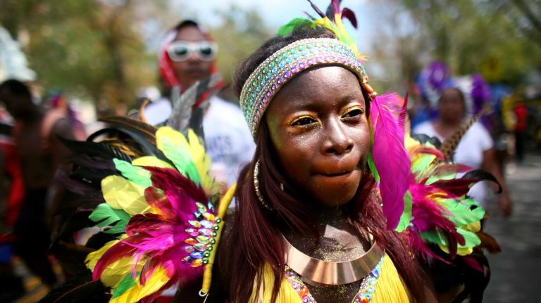 Revelers participate in the annual West Indian Day parade held on September 1, 2014 in the Brooklyn borough of New York City. The parade, which draws a crowd of a million plus, celebrates Caribbean culture. 