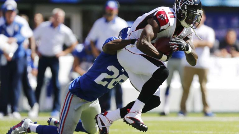 Wide receiver Julio Jones #11 of the Atlanta Falcons is tackled by cornerback Prince Amukamara #20 of the New York Giants after making a catch during an NFL game at MetLife Stadium on Sunday, Sept. 20, 2015.