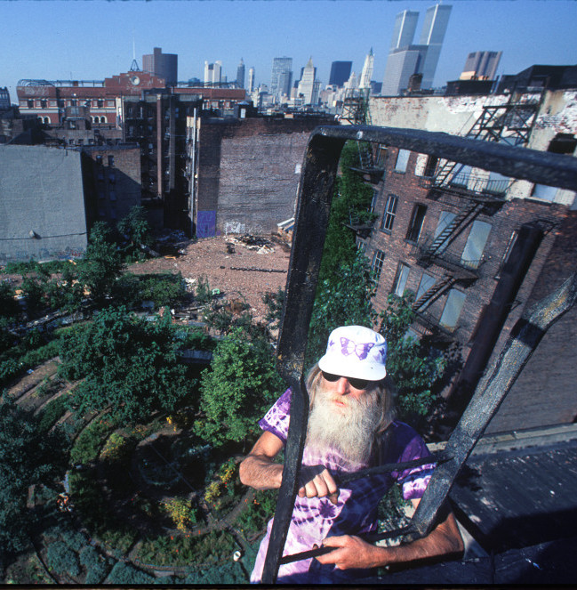 Adam Purple atop his building's fire escape above the Garden of Eden. Photo copyright Harvey Wang