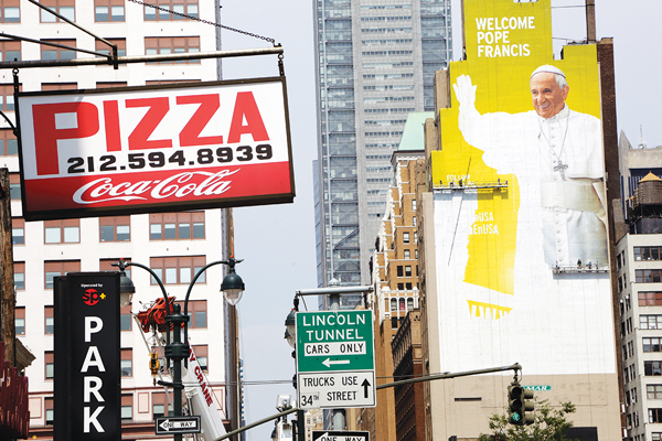 A mural in honor of Pope Francis’s visit as it was recently being painted on a building in West Midtown Manhattan.