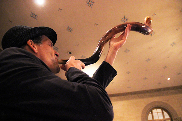 Marc Wishengrad blew a shofar from the balcony at the Rosh Hashanah service.   Photo by Tequila Minsky