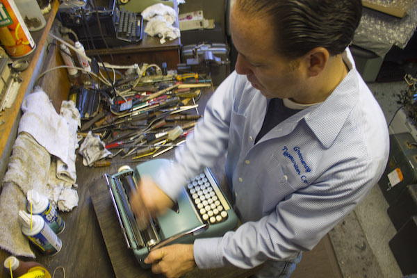 A cache of old parts acquired over the years makes repairs happen at Gramercy Typewriter Company where Justin Schweitzer (above) works with his father Paul. Downtown Express photos by Zach Williams