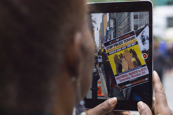 Protests Annoying? Murder Is Infuriating, Say #RiseUpOctober Participants 7 Footage from the demonstration quickly became available online as activists shot videos and photos and posted them to social media. Photo by Zach Williams.