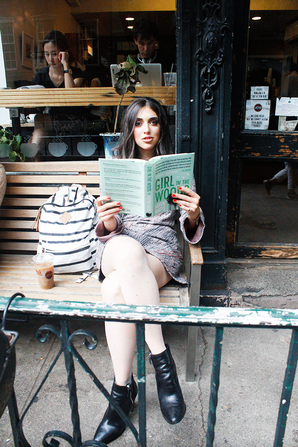 Aspen Matis reading her new adventure memoir outside of Joe, at 141 Waverly Place, where she can always be seen with a cup of coffee.