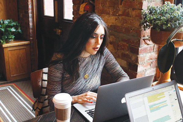 Aspen Matis, author of “Girl in the Woods,” writing her new novel, “Cal Trask,” in Stumptown Coffee, at 30 W. Eighth St. Photo by Misha Sesar