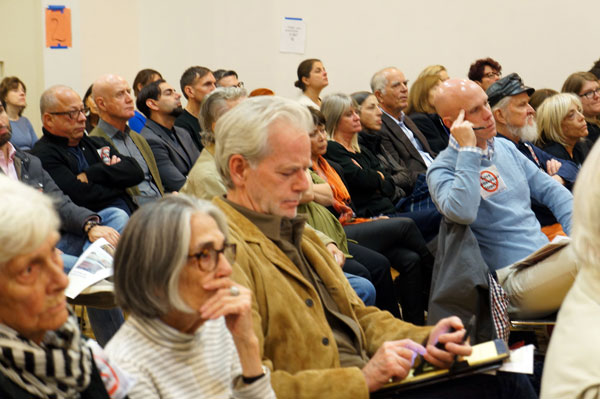 The crowd, listening intently to the design experts’ arguments, wasn’t swayed by their presentation.  Photo by Zack Winestine