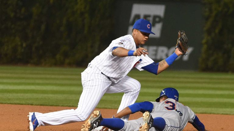 NLCS Game 3: Mets vs. Cubs 66 Chicago Cubs second baseman Starlin Castro (13) tags out New York Mets rightfielder Curtis Granderson (3) as he attempts to steal second base in the first inning during Game 3 of the NLCS against the Chicago Cubs at Wrigley Field on Tuesday, Oct. 20, 2015.