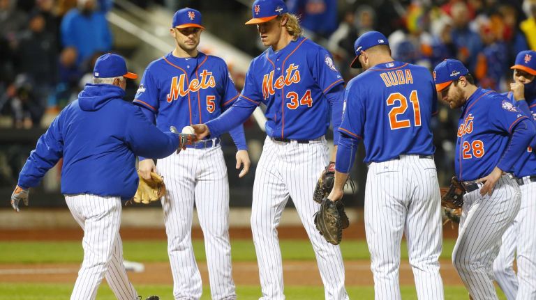 New York Mets manager Terry Collins (10) takes the ball from New York Mets starting pitcher Noah Syndergaard (34) in the sixth inning during Game 2 of the NLCS against the Chicago Cubs at Citi Field on Sunday, Oct. 18, 2015.