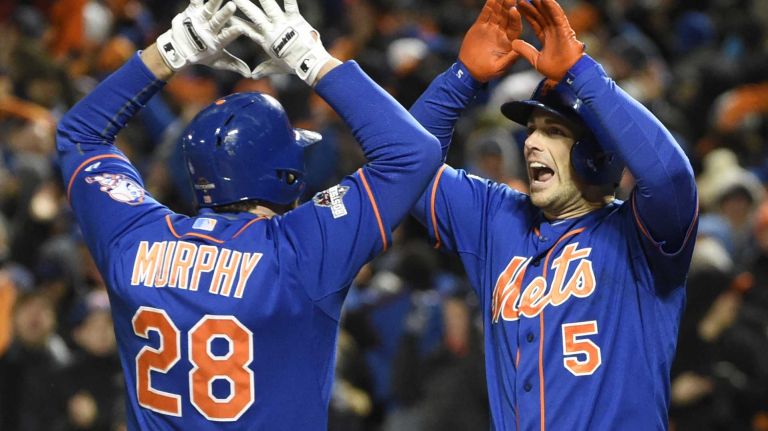 New York Mets second baseman Daniel Murphy (28) high-fives third baseman David Wright (5) at home plate after hitting a two-run home run in the first inning during Game 2 of the NLCS against the Chicago Cubs at Citi Field on Sunday, Oct. 18, 2015.