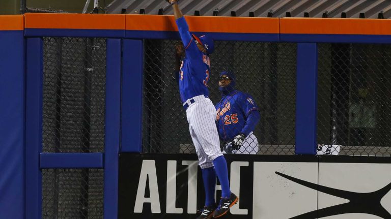 New York Mets right fielder Curtis Granderson (3) makes the leaping catch on the ball hit by Chicago Cubs left fielder Chris Coghlan (8) in second in ning during Game 2 of the NLCS against the Chicago Cubs at Citi Field on Sunday, Oct. 18, 2015.