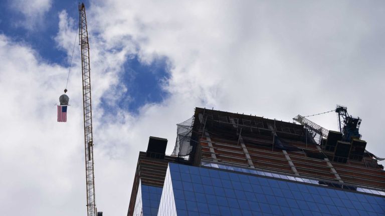 A concrete bucket draped with an American Flag rises towards the top of 10 Hudson Yards during a Topping Out ceremony Wednesday, Oct. 7, 2015. 
