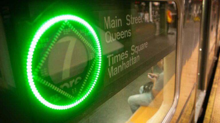 Passengers aboard the 7 train in Times Square Station, Wednesday, July 30, 2014. 