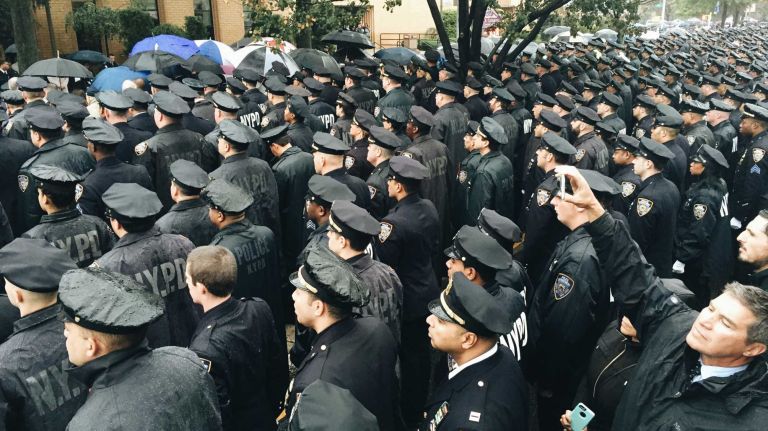When you bash immigrants, you bash NY's Finest 2 Police officers gather at the Greater Allen A.M.E. Cathedral in Jamaica, Queens on Wednesday, Oct. 28, 2015, for the funeral of slain NYPD Officer Randolph Holder.