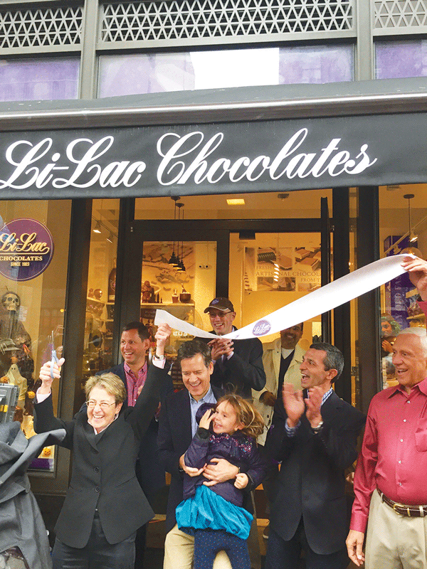 At Saturday’s ribbon-cutting for the new Li-Lac Chocolates store, clockwise from front row left, Assemblymember Deborah Glick; Anthony Cirone and Chris Taylor, Li-Lac’s co-owners; Anwar Khoder, Li-Lac’s master chocolatier; Anthony Cirone, the co-owner’s father; and state Senator Brad Hoylman with his daughter, Silvia.