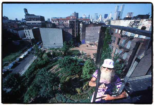 Adam Purple at the top of his fire escape on Forsyth St., overlooking his Garden of Eden.    Photo copyright Harvey Wang