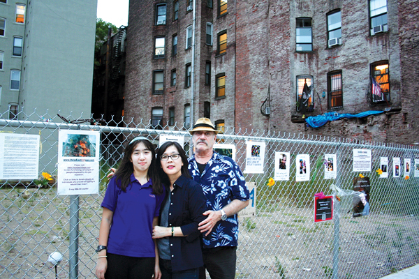 The Lipsky family in front of the vacant site at E. Seventh St. and Second Ave. where three buildings were leveled and two men died after a gas explosion and fire on March 26. Their building, 125 Second Ave., survived the blast.