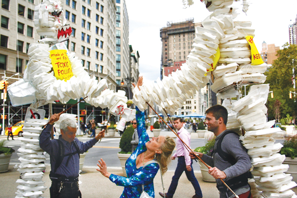 On the People’s Climate Movement Day of Action, Wed., Oct. 14, two volunteers carried the giant Styrofoam puppets up to Flatiron Plaza, where the out-of-control environment-destroying monsters turned against each other, as a woman tried to break up the clash.   Photo by Yannic Rack