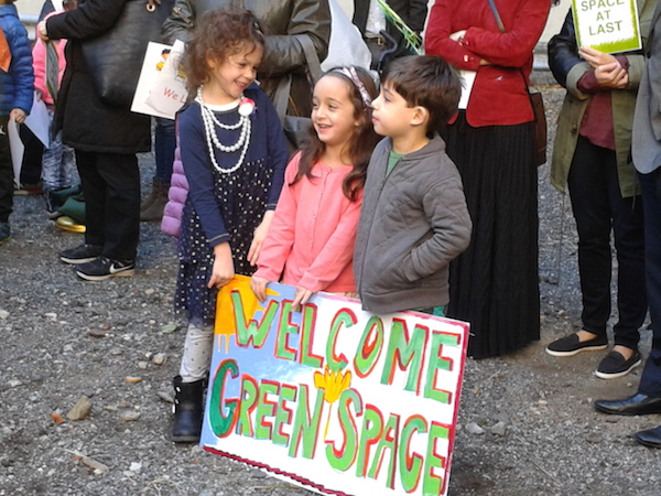 Done Deal: W. 20th St. Gets Its Park 3 Some kids from the neighborhood held signs, some said “Hi!” to those giving speeches, others kicked up gravel — and they’ll all grow up with a nearby park. Photo by Scott Stiffler.
