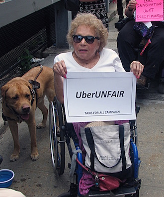 Disability Advocates Charge Uber Undercuts Accessible Rides Push 1 United Spinal Association, Taxis For All Campaign, and other wheelchair user advocates held a “roll-in” outside Uber’s West Side headquarters this past July. | UNITEDSPINAL.ORG
