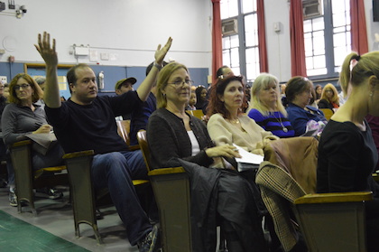 At one of the rezoning hearings attended by parents, an audience member gestures in exasperation. | JACKSON CHEN 