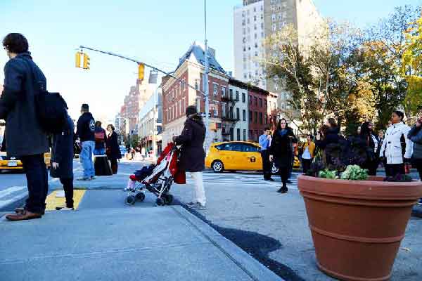 Photo courtesy NYC DOT A new concrete expanded pedestrian island at the Christopher St. subway station is among the intersection’s improvements. 