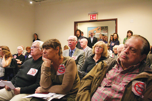Photo by Yannic Rack Villagers, shown listening to testimony at the Landmarks Preservation Commission, turned out in numbers to speak out against the plan.