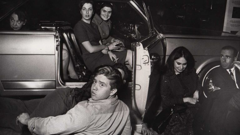 Stranded commuters take advantage of a new car on display in the lobby of Grand Central Terminal during the blackout on Nov. 9, 1965.