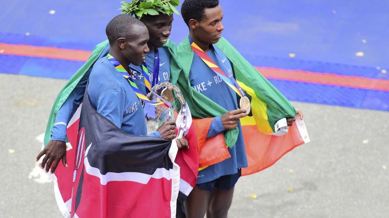 From left, second-place finisher Geoffrey Kamworor of Kenya, winner Stanley Biwott of Kenya and Lelisa Desisa of Ethiopia receive their medals for racing in the New York City Marathon in Manhattan on Sunday, Nov. 1, 2015.
