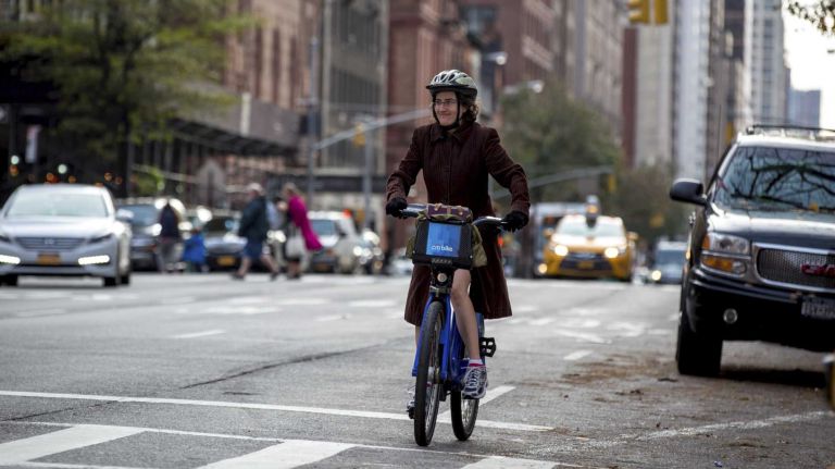 A cyclist rides along Amsterdam Avenue on the Upper West side of Manhattan on Wednesday, Nov. 11, 2015. Currently, their is no bike lane in this stretch of Amsterdam Avenue between 72nd and 110th streets, but the city is planning to reconfigure 25% of the parking spaces along the route to create a new two-mile-long bike lane and pedestrian islands.
