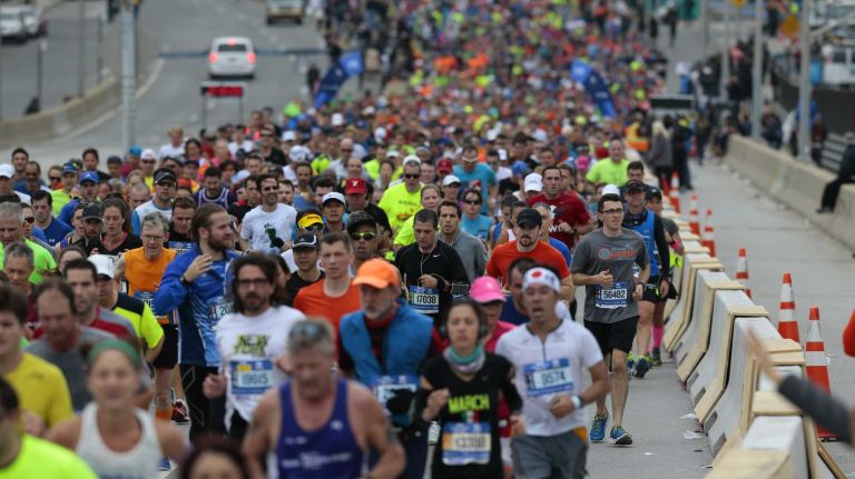 New York City Marathon participants run along the race route in Brooklyn on Nov. 1, 2015.