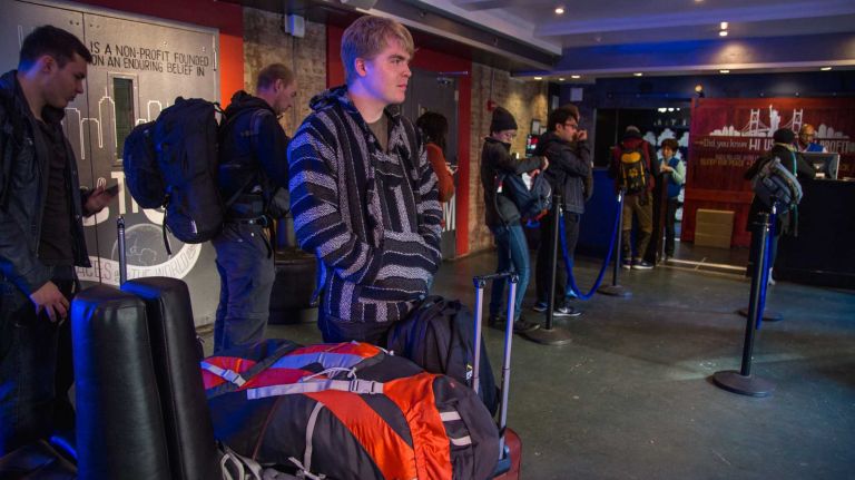 Travis Ferrier of England waits for a shuttle after staying the night at the HI NYC hostel at 891 Amsterdam Ave. on Nov. 23, 2015.