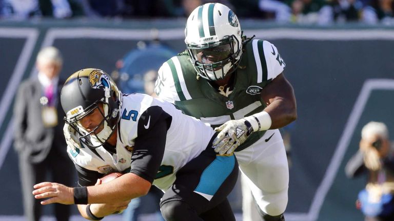 Blake Bortles #5 of the Jacksonville Jaguars is stopped on a run in the first half by Lorenzo Mauldin #55 of the New York Jets at MetLife Stadium on Sunday, Nov. 8, 2015 in East Rutherford, N.J.
