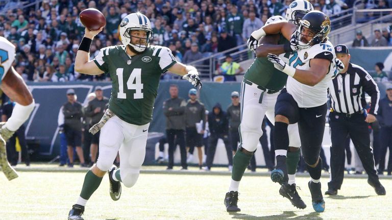 Ryan Fitzpatrick #14 of the New York Jets throws a touchdown pass in the first quarter against the Jacksonville Jaguars to teammate Eric Decker at MetLife Stadium on Sunday, Nov. 8, 2015 in East Rutherford, N.J.