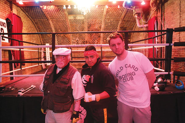 From left, Carlos Castillo, Adam Gonzoga and Joey Goodwin during a break in the action at Overthrow. Castillo, from Monterey, Mexico, and Hell’s Kitchen, worked with famed light-heavyweight champ Archie Moore and also trained his own son, who was a Golden Gloves champion. Gonzoga, an amateur fighter, is being trained by Goodwin a.k.a. “Soho Joe,” who runs Overthrow.