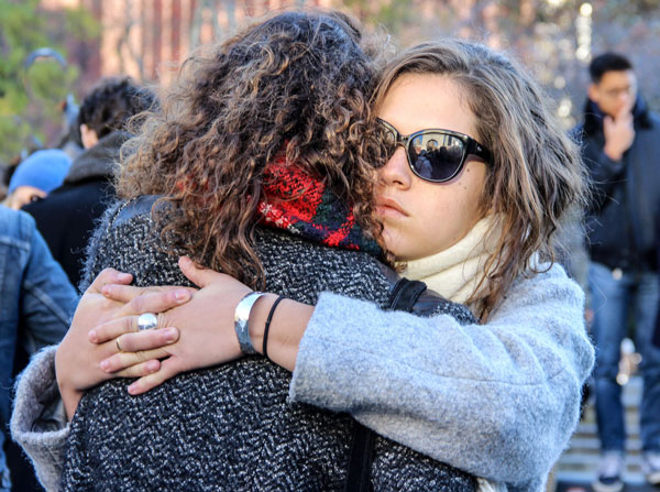 French vigil in Wash. Square, again, after night of horror 5 Photo by Tequila Minsky Anais Bambili, left, who had just learned her best friend’s boyfriend died in the Paris attacks, was consoled by her friend Sophie Gousset at Saturday’s vigil in Washington Square.