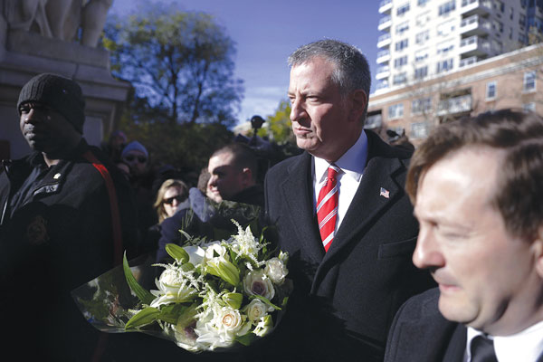 French vigil in Wash. Square, again, after night of horror 3 Photo by William Alatriste / NYC Council Mayor Bill de Blasio arriving at Saturday’s vigil with a bouquet of white roses and lilies, which he left on a memorial under the arch.
