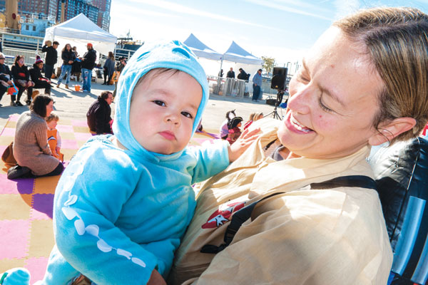 Downtown Express photos by Milo Hess (Top left) Leo and Dylan Van Der Sande, both 18 months old, came dressed as Luke Skywalker and Chewbacca, riding in a Millennium Falcon built — and powered — by their dad, Erik. (Top right) Sebastian Krautmann was dressed as an octopus, but it was him mom, Elizabeth Lara, who kept him wrapped in her arms — when he wasn’t on the merry-go-round. (Right) The highlight of the event for 14-month-old Faye Cua was trying cotton candy for the first time. (Far right) Superboy Raymond Ortiz, 2, flew down from the Bronx to take in the sights at Tribeca’s Pier 26. (Above) Interactive story-tellers the Story Pirates were a big hit with the kids. 