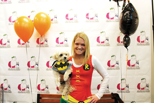 Downtown Express photo by Yeonji Wu Shelter Chic co-founder Amanda Folk plays Robin to her pup Lenny’s Batman at the pet boutique and adoption center’s Halloween party on Oct. 31. 