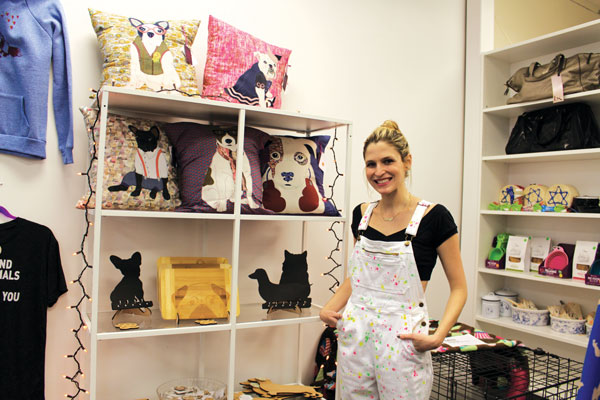 Shelter Chic president and co-founder Britney Feldman shows off some of the high-end, pet-themed items on offer.