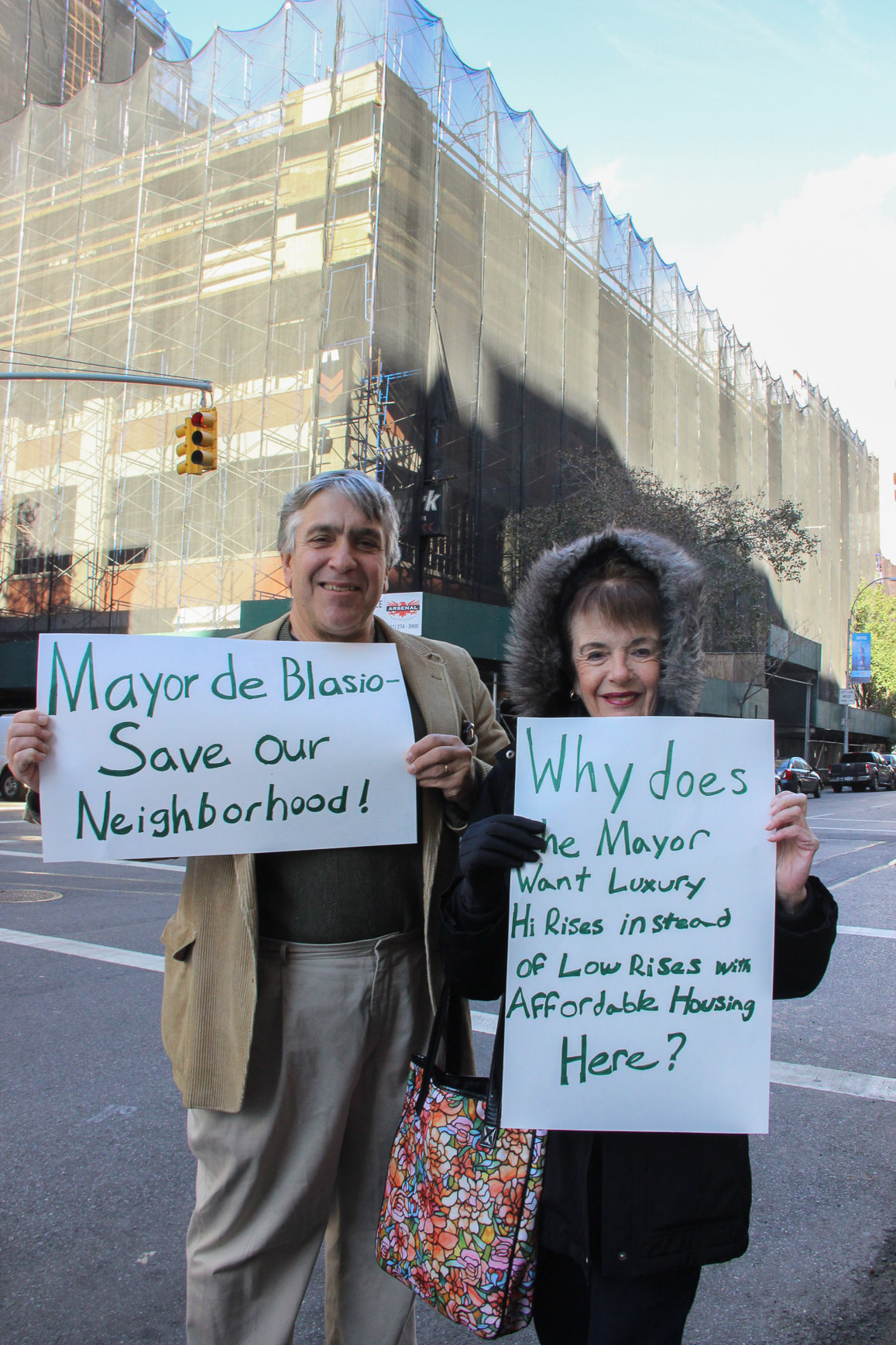 Standing in from of the former Bowlmor Lanes, on which demolition recently started, local residents spell it out for Mayor de Blasio: Low and affordable, not tall and luxury.